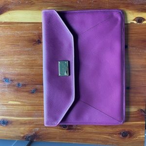 Michael Kors laptop case. Burgundy/maroon color on outside, gold inside.